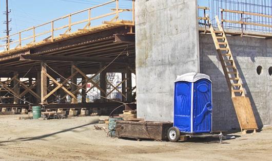 job site necessities a group of portable toilets ready for use by the crew